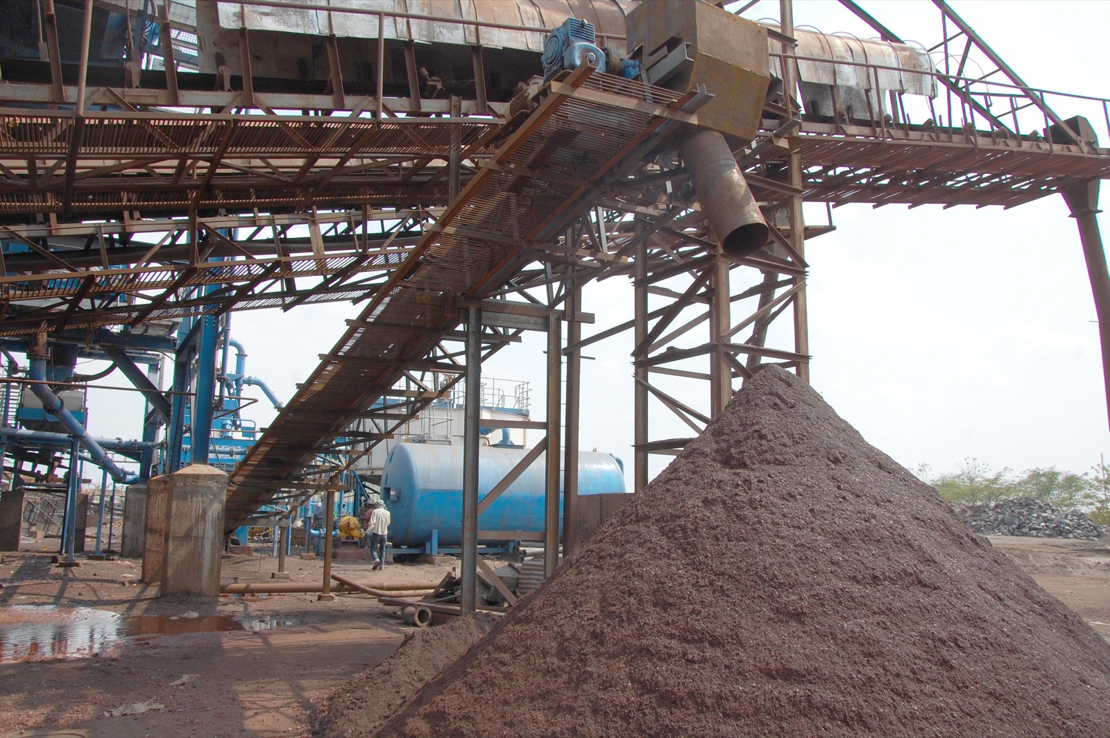 Iron ore fines stockpiled beneath a conveyor
